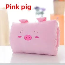 Pink pig-shaped pillow on a white surface with a blurred background
