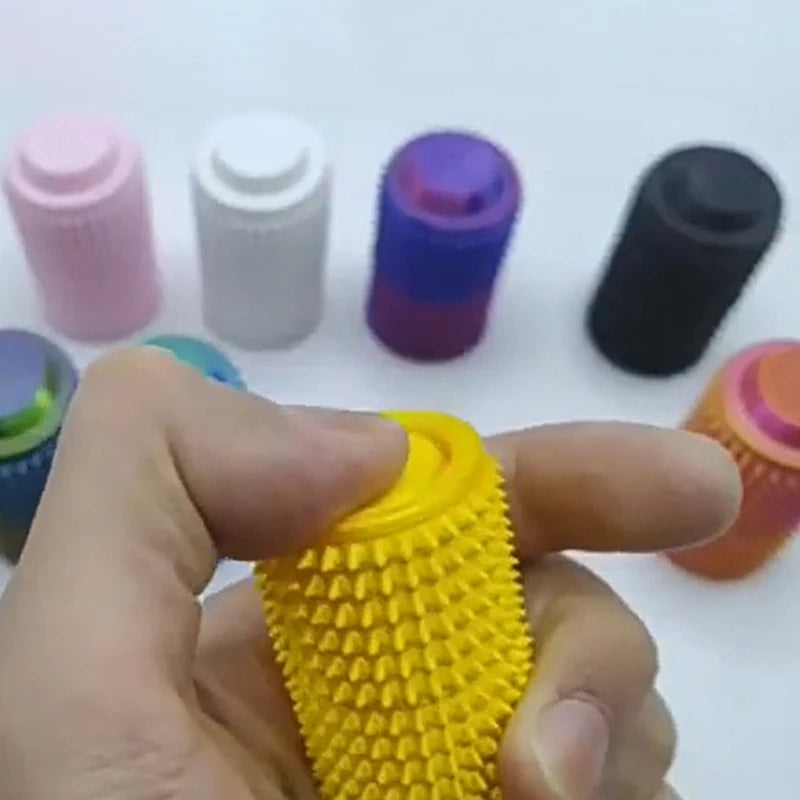 Hand holding a yellow textured object with colorful cylindrical objects in the background