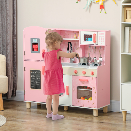 Child playing with a pink toy kitchen set in a room.