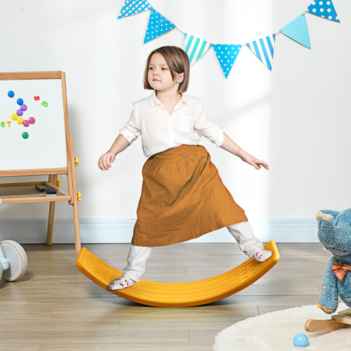 hild standing on dual-sided wobble board supporting posture and vestibular control