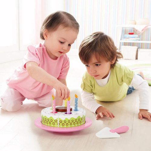 Child using SOKA wooden cake playset to practise sharing routines and hosting interaction