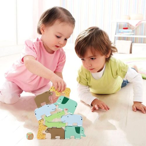 Child building tower with SOKA animal blocks to develop focus, spatial reasoning and coordination