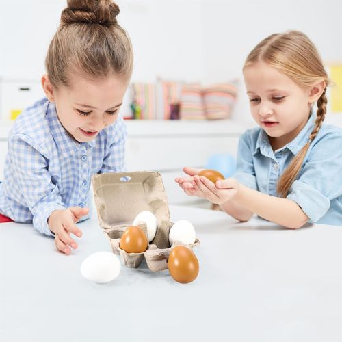 Child serving breakfast using brown and white wooden eggs in realistic food setup