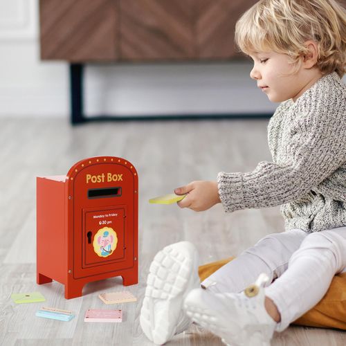 Child posting a wooden letter into elephant mailbox to build communication routines and coordination