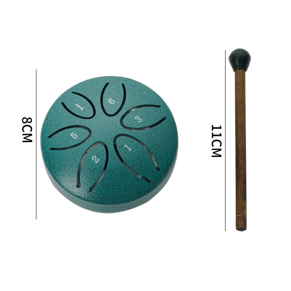Compact green steel tongue drum with mallets placed beside for easy play