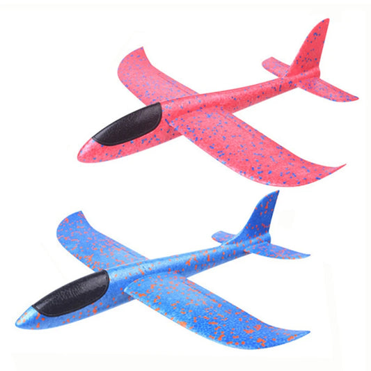 Two colorful foam gliders, one pink and one blue, on a white background.