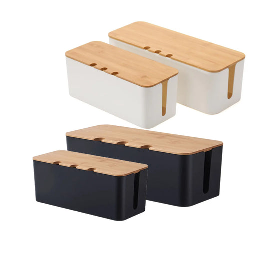 Cable management box placed near a wall socket, concealing multiple cords and plugs within a simple, minimal housing