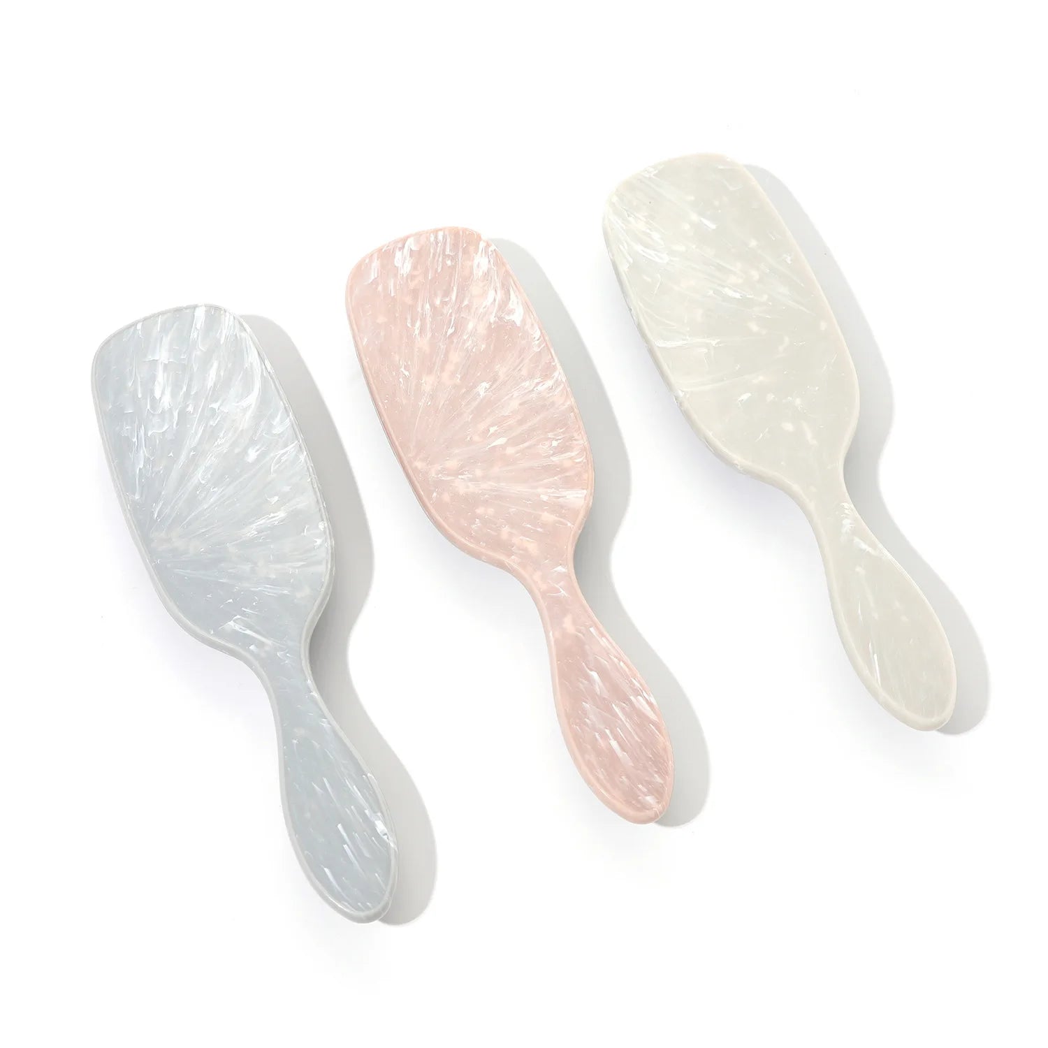 Soft anti-static hair brush with marbled finish and flexible bristles for sensory-friendly detangling and static-free styling