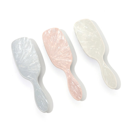 Soft anti-static hair brush with marbled finish and flexible bristles for sensory-friendly detangling and static-free styling