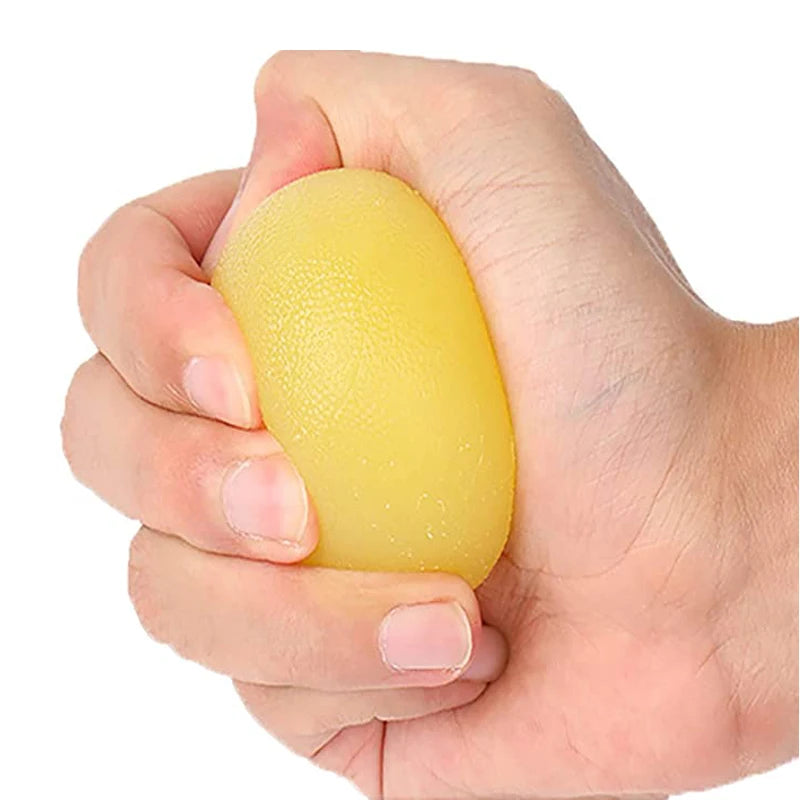 Hand holding a yellow stress ball against a white background