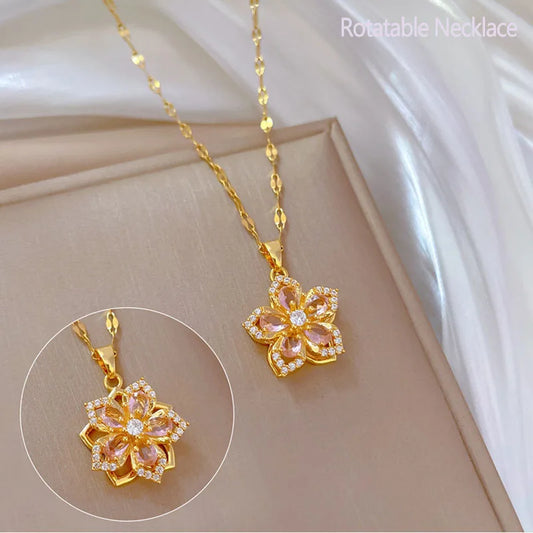 Gold necklace with a pink flower pendant on a white background