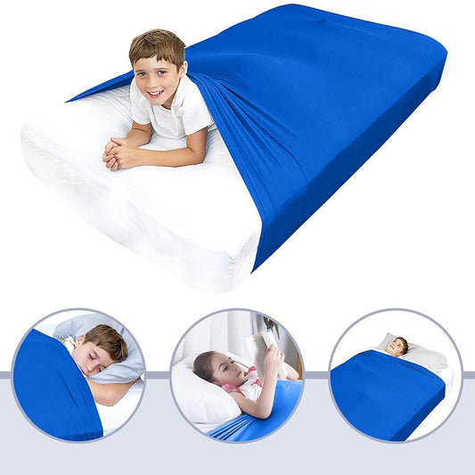 Sensory compression blanket shown draped across a bed with gentle folds and soft stretch fabric in calm neutral tones