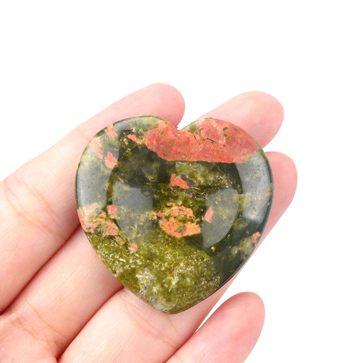 Heart-shaped polished quartz worry stone resting in palm