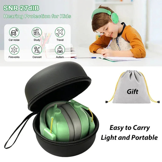 Pair of kids’ noise-cancelling ear defenders in soft colours, shown folded on desk with padded ear cups and adjustable headband
