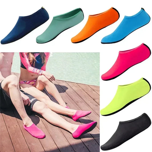Unisex water shoes on sandy beach, showing non-slip sole and breathable mesh
