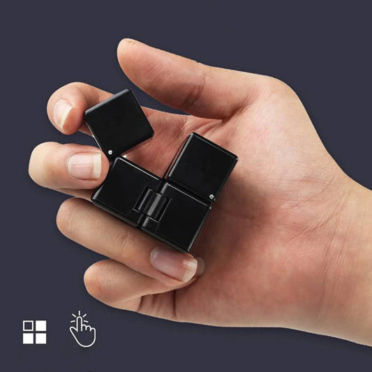 Hand holding a small black device with a dark background