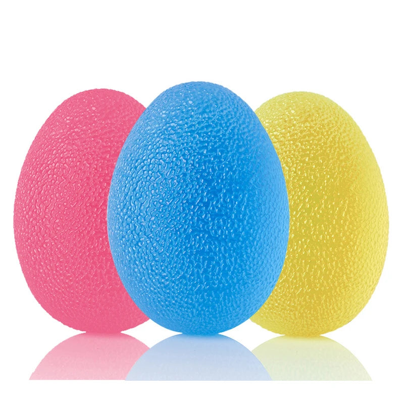 Three textured stress balls in pink, blue, and yellow on a white background