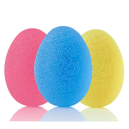 Three textured stress balls in pink, blue, and yellow on a white background