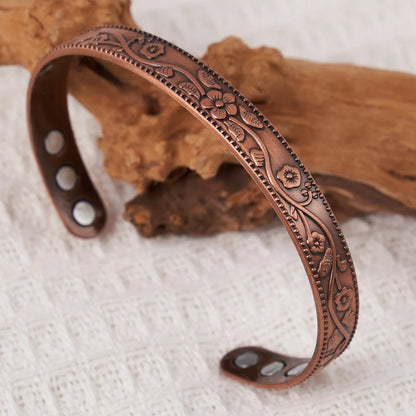 Magnetic energy wristband with vintage floral detail and antique copper finish designed for sensory-friendly wear