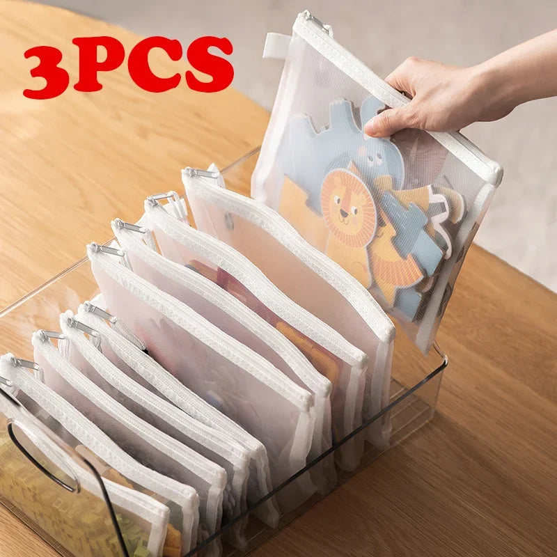 Three toy storage bags in assorted sizes, shown upright with soft handles and spacious interiors for organised play