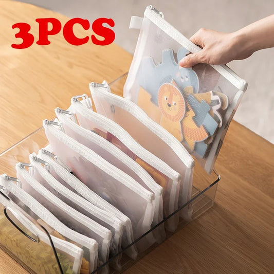 Three toy storage bags in assorted sizes, shown upright with soft handles and spacious interiors for organised play