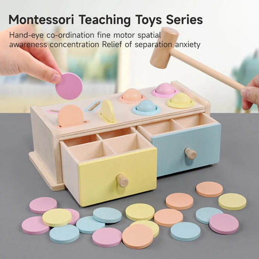 A wooden toy box with multiple compartments, containing colorful discs and blocks, used for sorting and stacking activities by a child.