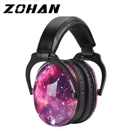 Colourful ZOHAN kids ear defenders with padded cups and graffiti-style design, displayed on a desk with sensory accessories