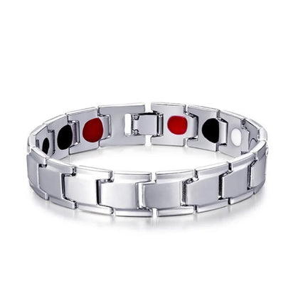 Silver bracelet with black and red circular elements on a white background