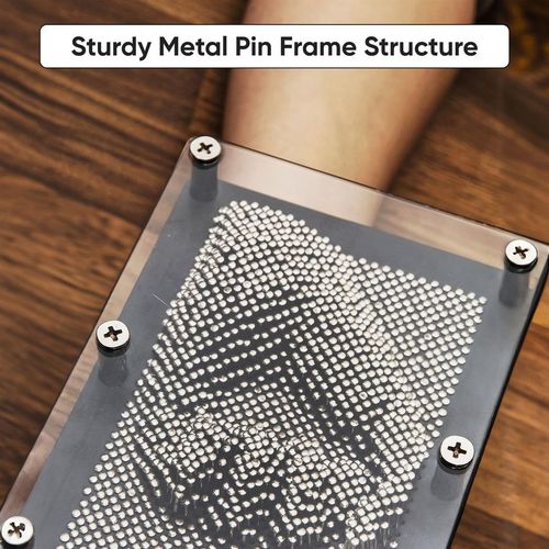 Black 3D metal pin art frame displaying hand impression, designed for sensory-friendly tactile play.