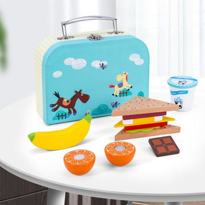 Close-up of wooden play food pieces arranged inside picnic box for imaginative storytelling