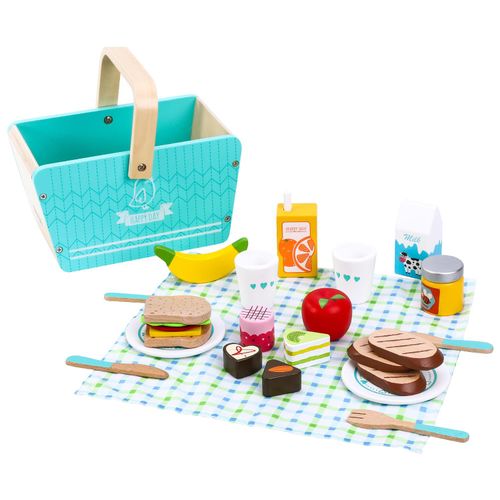 Children's toy picnic set with a basket, food items, and cutlery on a checkered cloth.