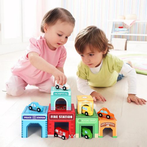 Child building SOKA stacking cube tower while placing wooden cars in matching scenes