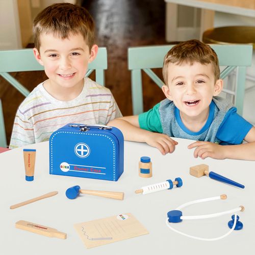 Two children playing with a toy doctor set on a table.