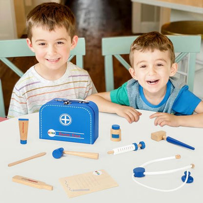 Two children playing with a toy doctor set on a table.