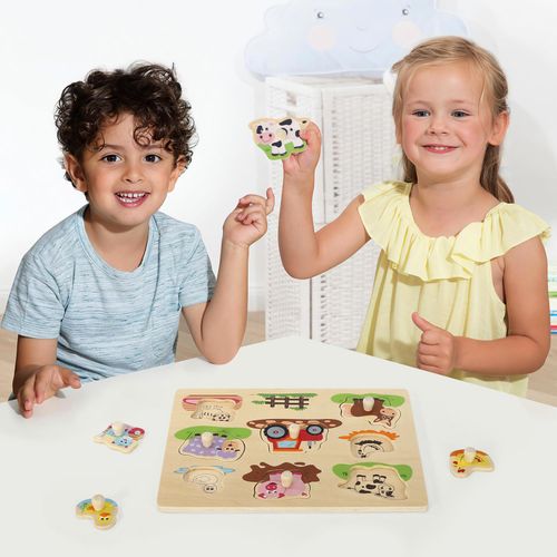 Child placing animal shapes into wooden board to build tactile confidence and descriptive skills