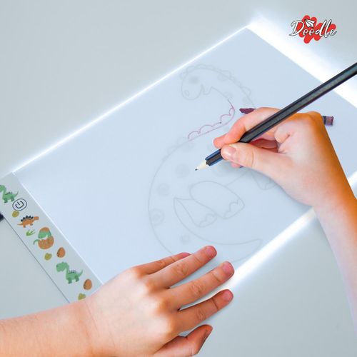 Dinosaur-themed LED tracing pad shown flat on desk with USB cable for sensory-friendly sketching