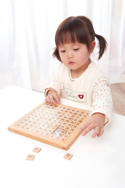 Child exploring number sequences using tactile wooden board and control panel