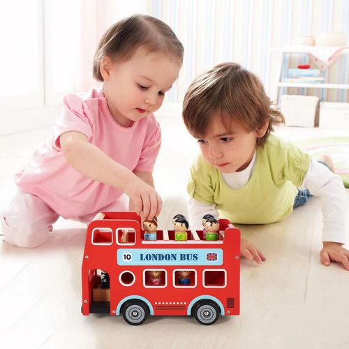 Child using London bus toy to explore imaginative transport play and spatial planning