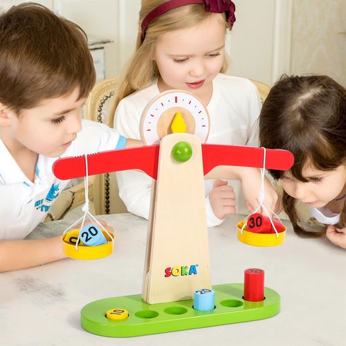 Bright wooden weights and scale setup shown on classroom table for hands-on educational play