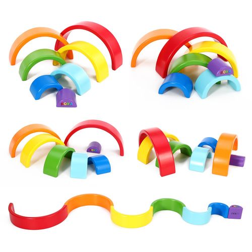 Wooden arc toy laid out in rainbow order for visual tracking and imaginative structures