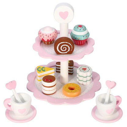 Two-tier pink cake stand with wooden pastries arranged for imaginative tea party setup